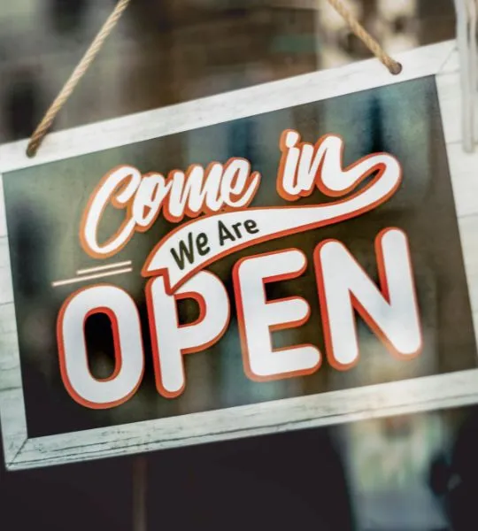 Hanging shop sign that reads Come in, We Are Open.